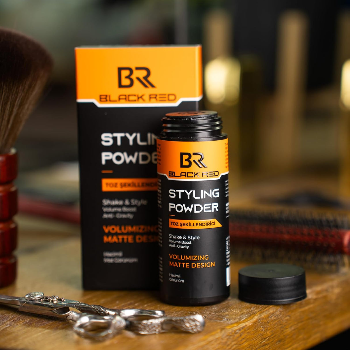 Black Red Styling Powder packaging on a wooden surface with grooming tools.